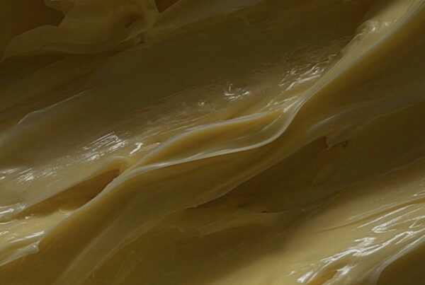 Close-up of the glossy, layered surface of freshly churned butter